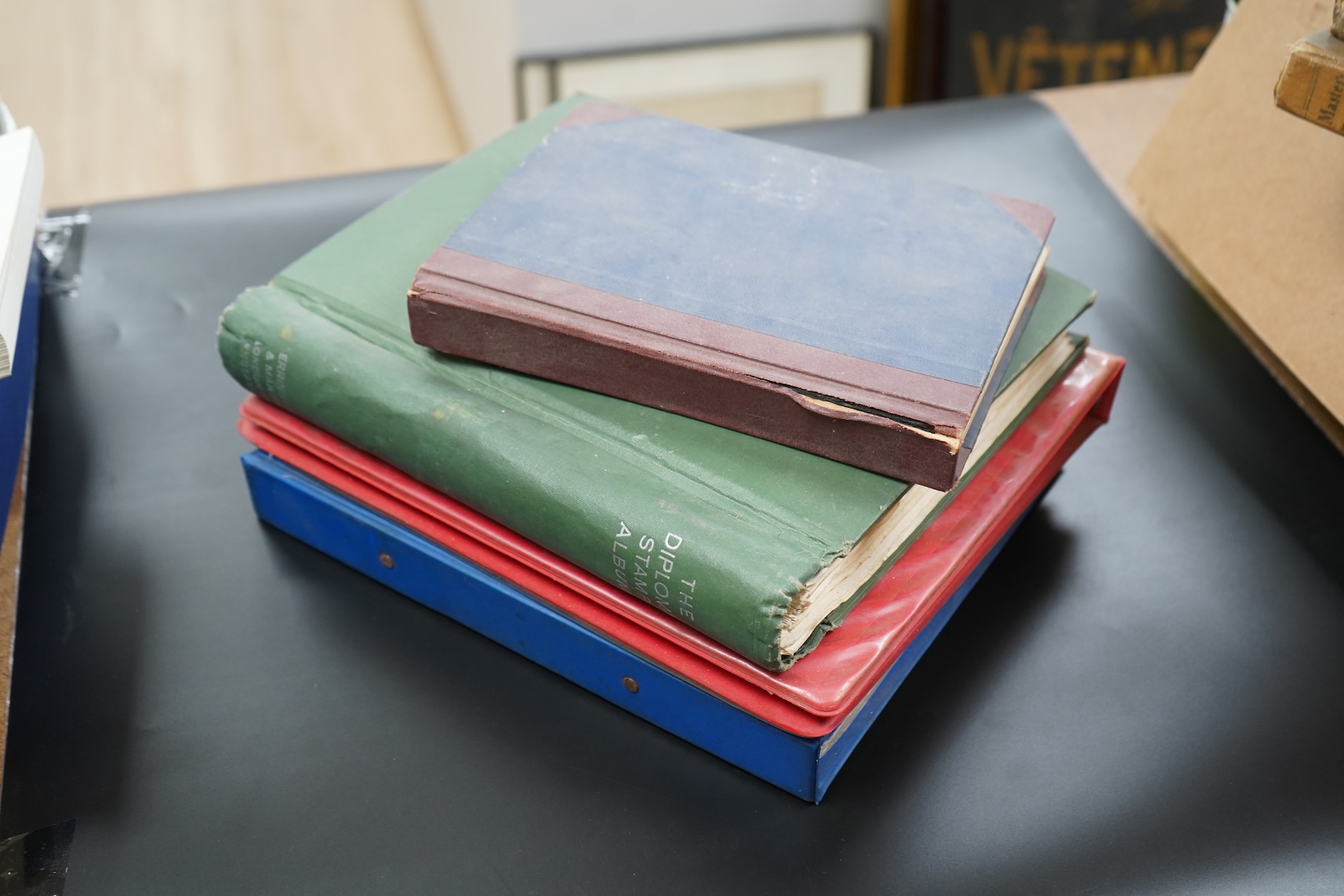 Four stamp albums including a first day cover album